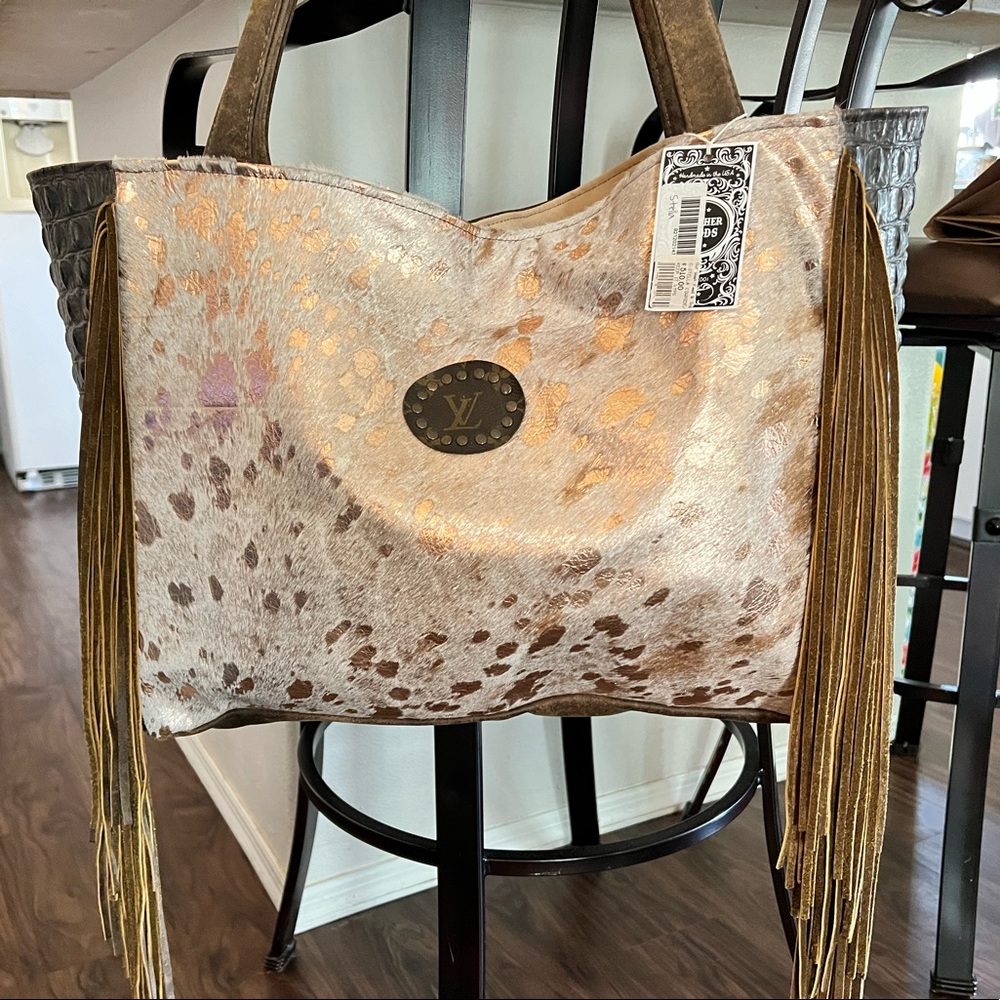 NWT Absolutely gorgeous cowhide, leather & fringe bag with Louis Vuitton patch.